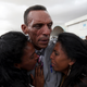 Adisalem Abu, reacts as he embraces his twin daughters, after meeting them for the first time in eighteen years, at Asmara International Airport after the Ethiopian Airlines ET314 flight arrived in Asmara, Eritrea July 18, 2018.